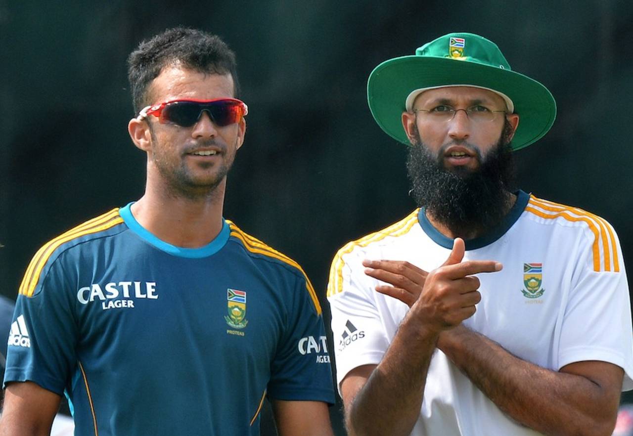 Guessing the swing: Hashim Amla and JP Duminy chat during a practice session, Hambantota, July 11, 2014