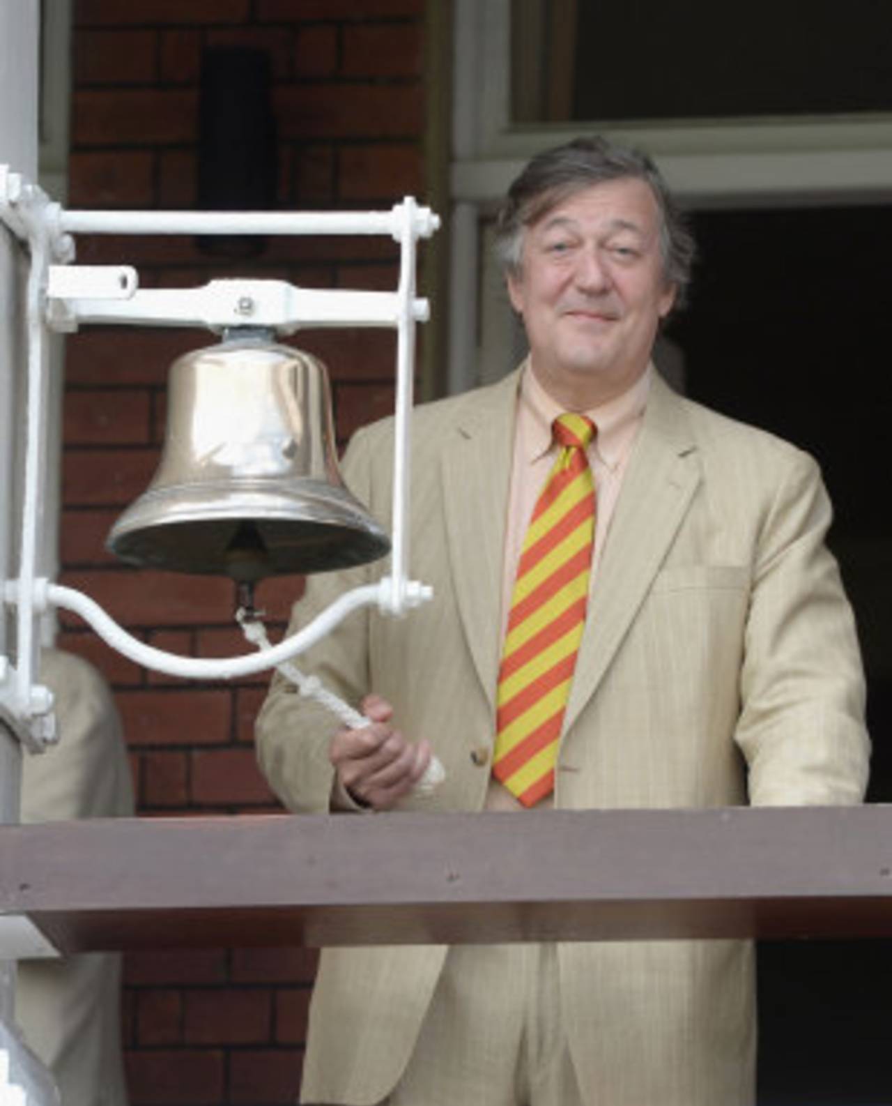 British actor Stephen Fry rings the five-minute bell ahead of the second day's play, England v India, 2nd Investec Test, Lord's, 2nd day, July 18, 2014