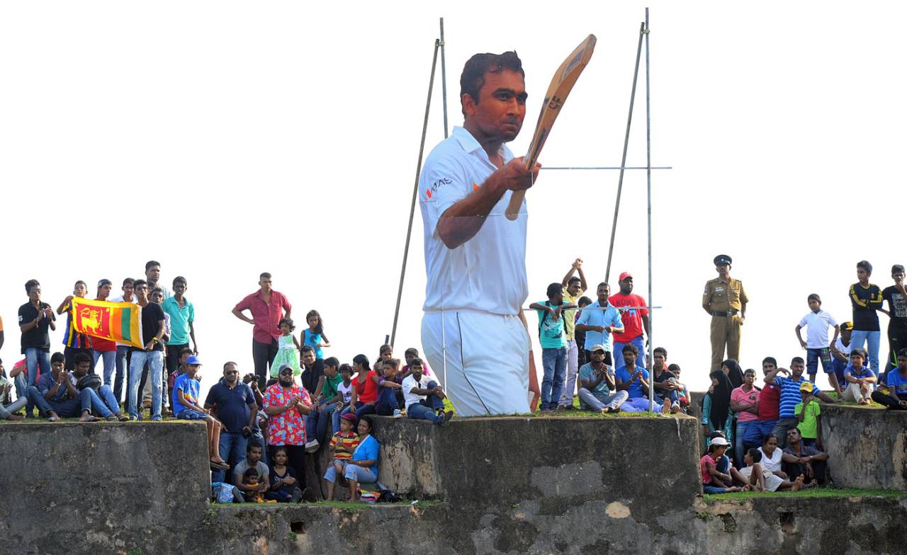 Spectators gather to watch the final day's play next to a cut-out of Mahela Jayawardene, Sri Lanka v Pakistan, 1st Test, Galle, 5th day, August 10, 2014