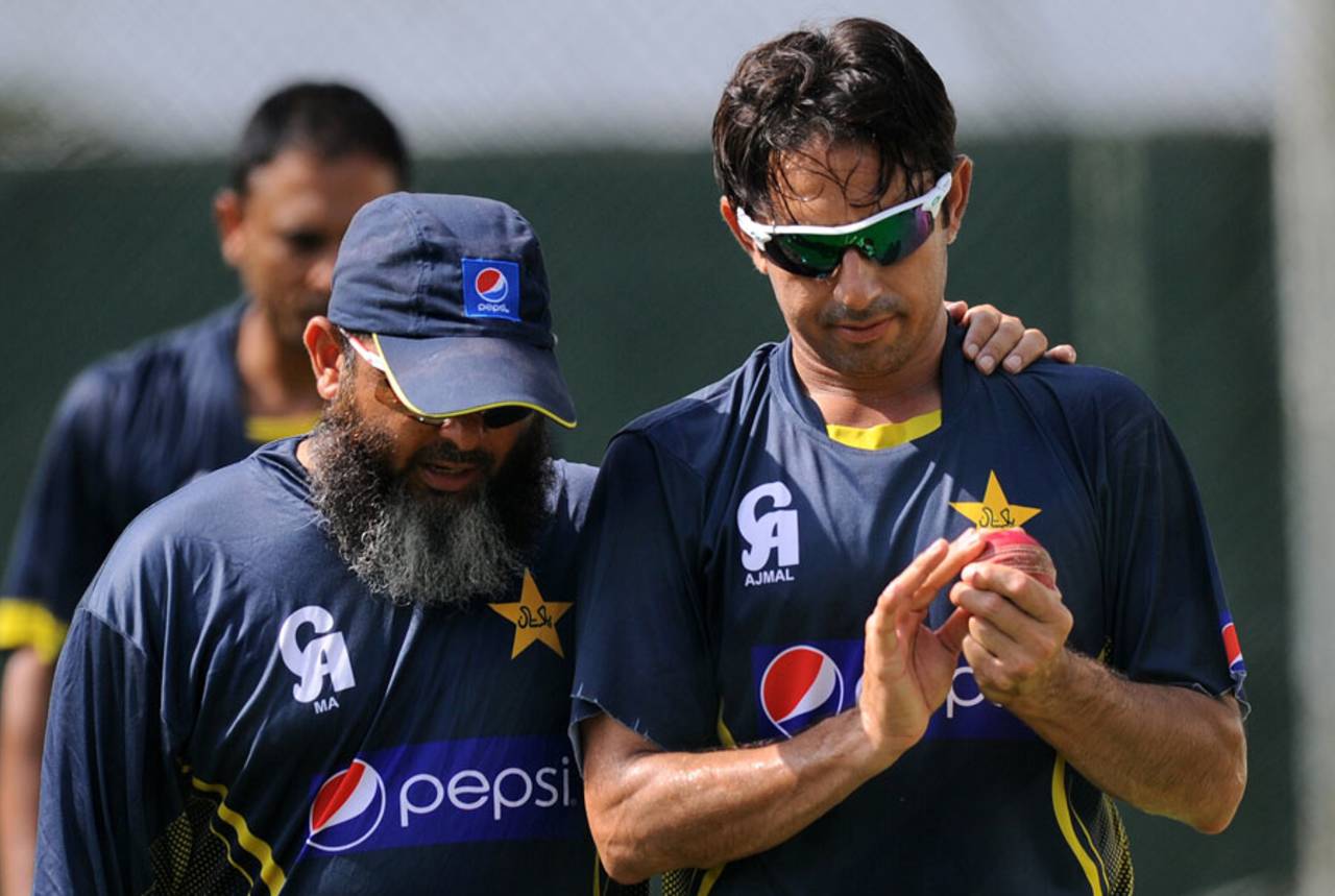 Mushtaq Ahmed has a word with Saeed Ajmal during training, Colombo, August 13, 2014