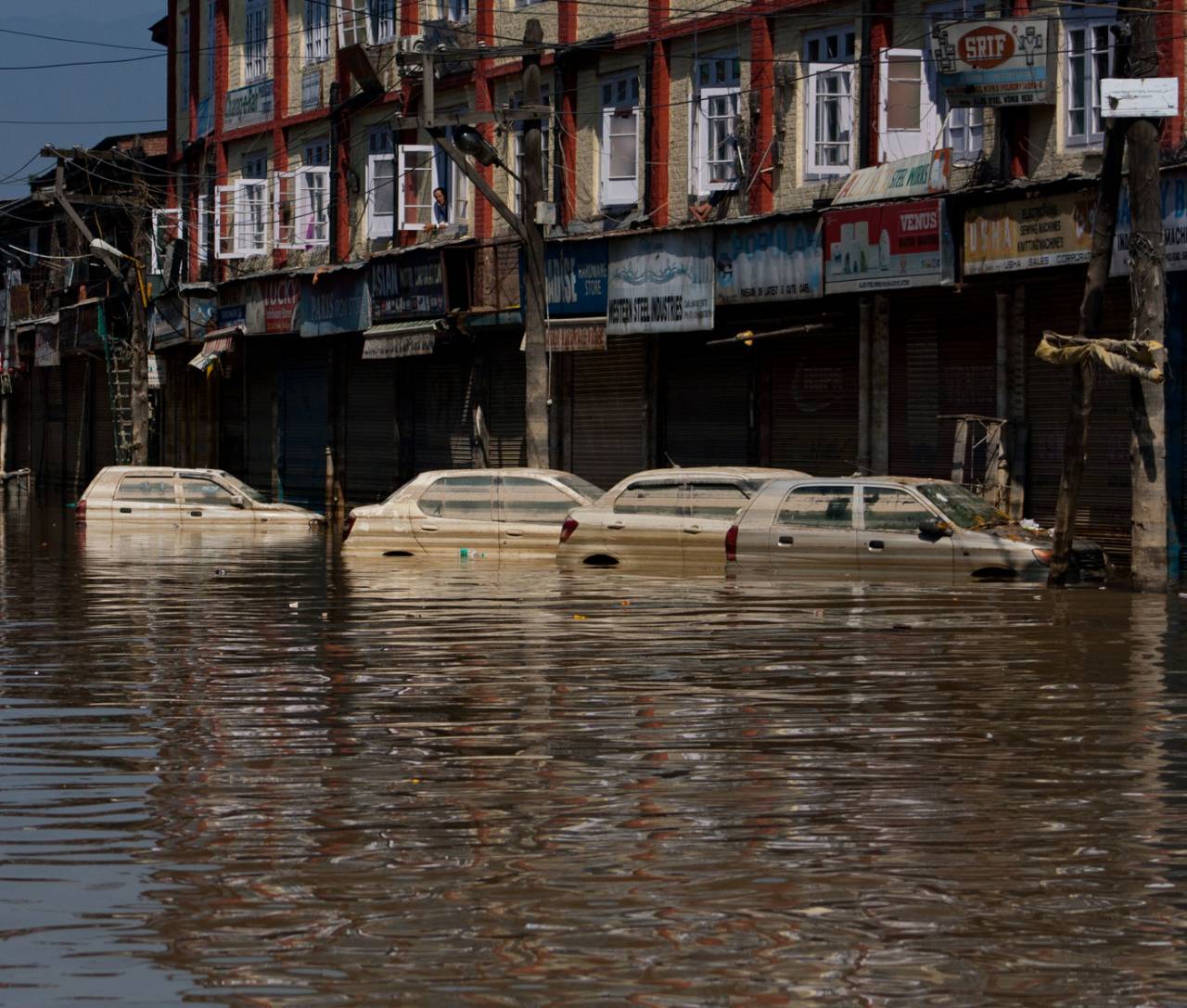 Cars sit submerged on a road in Srinagar's flooded city centre, September 17, 2014