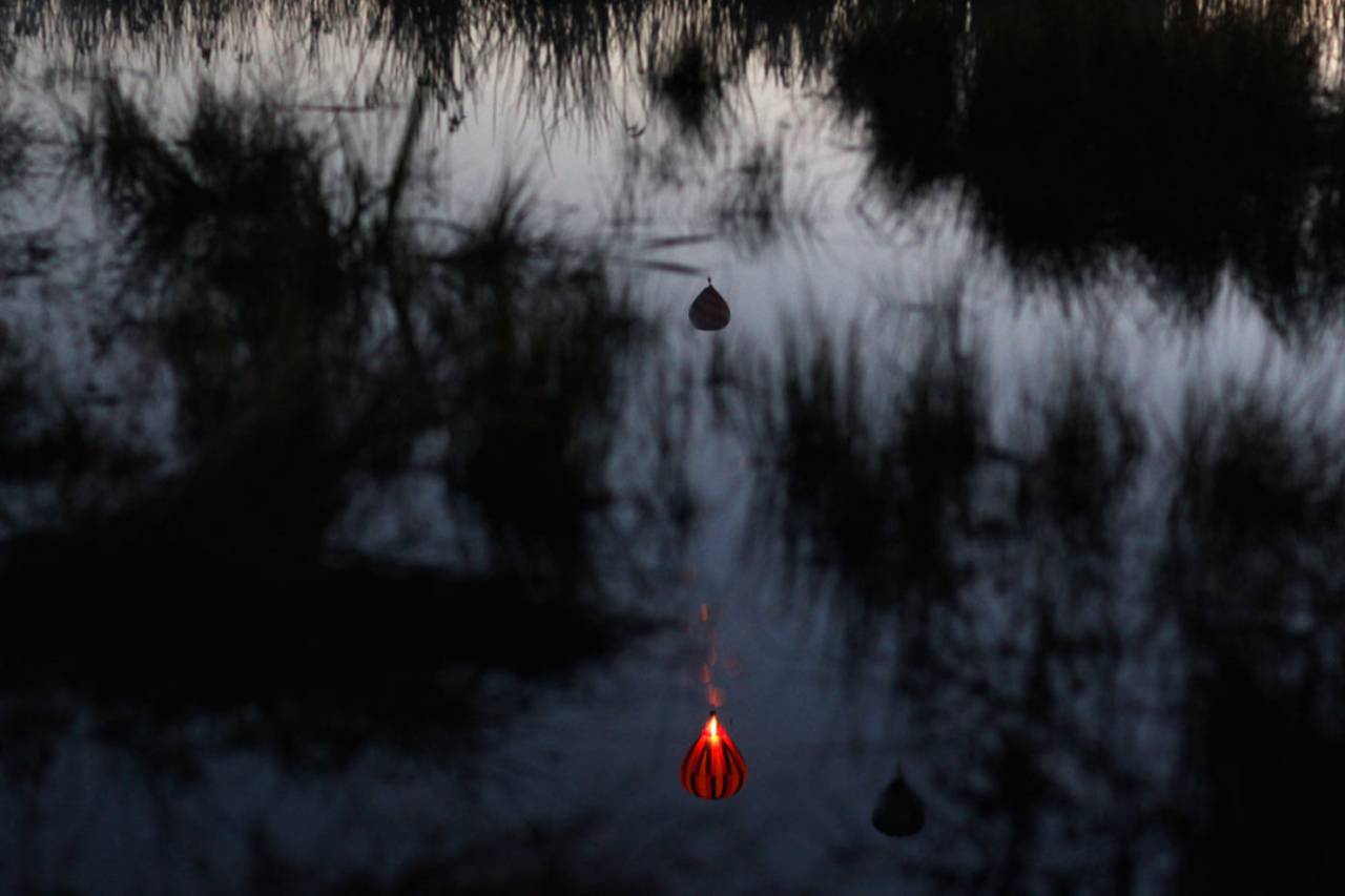Hot air balloons are reflected in the Hamilton lake during the Hot Air Balloon Festival in Hamilton, March 31, 2011