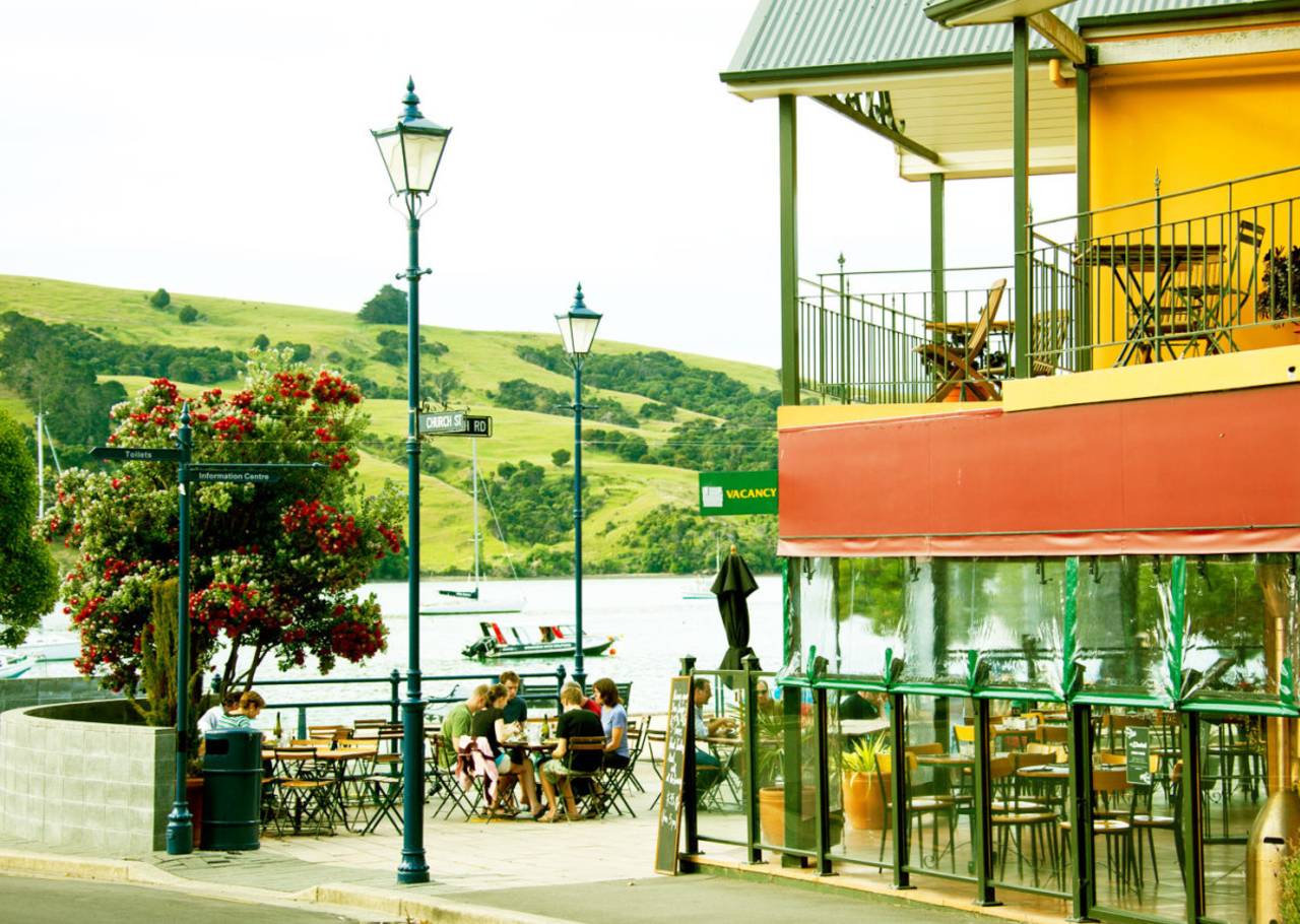 People sit in an outdoor cafe in Akaroa, near Christchurch, December 13, 2010