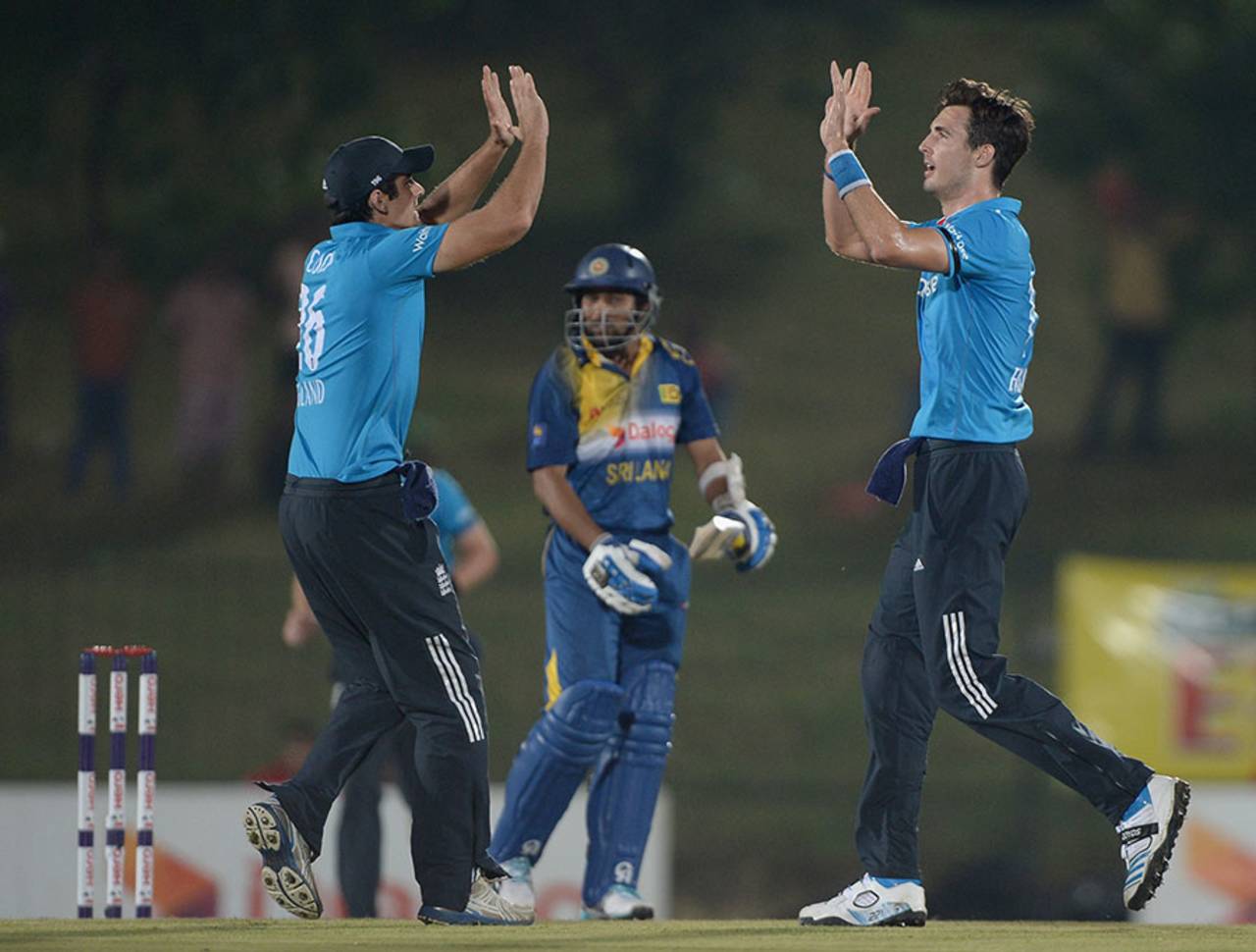 Alastair Cook and Steven Finn celebrate the dismissal of Tillakaratne Dilshan, Sri Lanka v England, 3rd ODI, Hambantota, December 3, 2014
