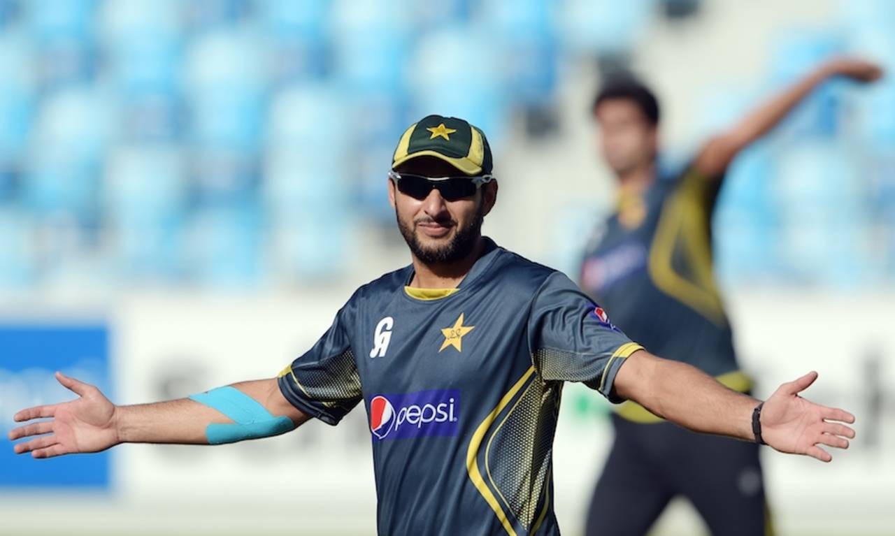 Shahid Afridi poses for the photographers, Dubai, December 7, 2014