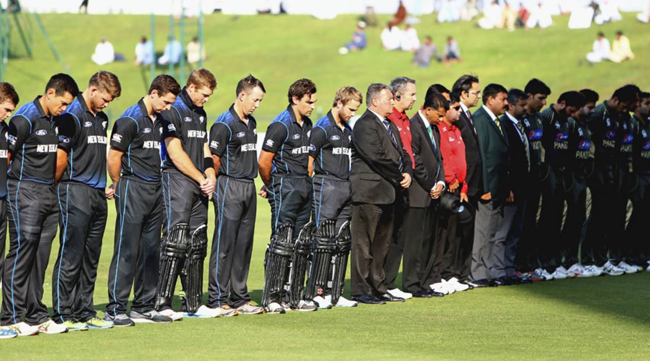 Match officials and the New Zealand and Pakistan teams observe two minutes of silence in memory of the victims of the Peshawar terror attack, Pakistan v New Zealand, 4th ODI, Abu Dhabi, December 17, 2014, 