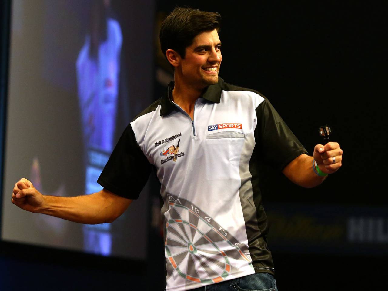 Alastair Cook plays a leg of darts against James Anderson, London, December 22, 2014