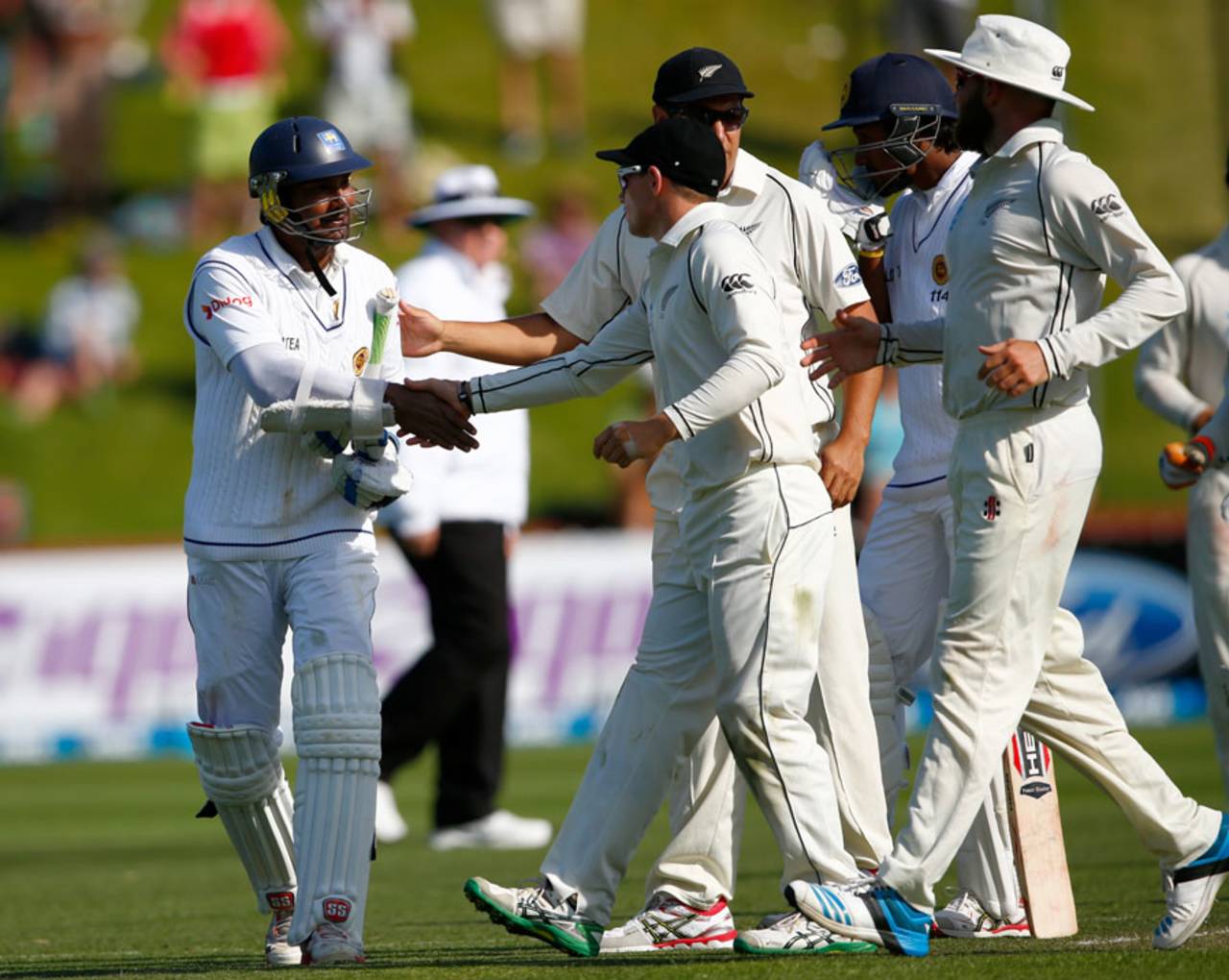 The New Zealand players congratulate Kumar Sangakkara after he is dismissed for 203, New Zealand v Sri Lanka, 2nd Test, Wellington, 2nd day, January 4, 2015