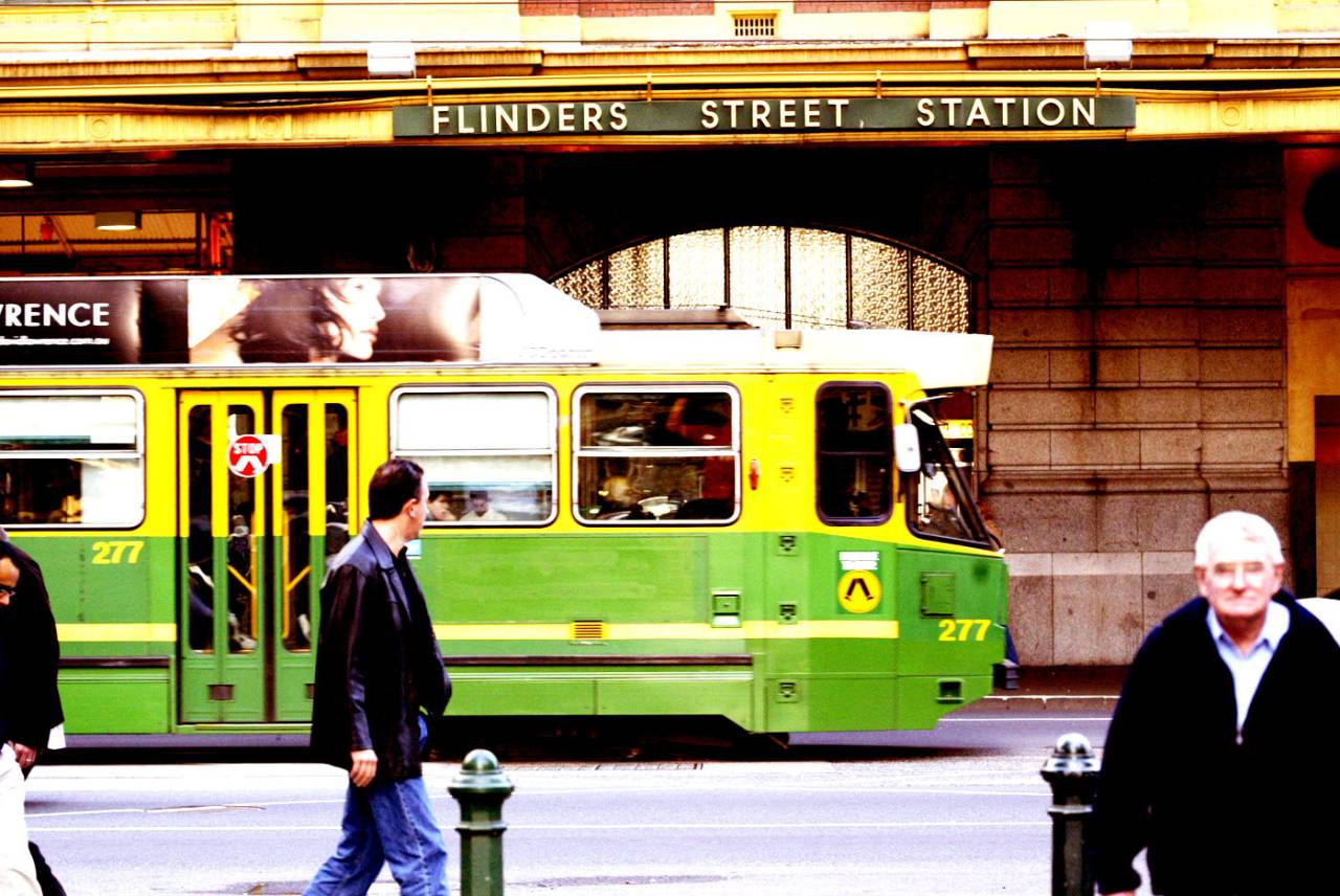 A tram travels past Flinders Street Station, Melbourne, August 4, 2002