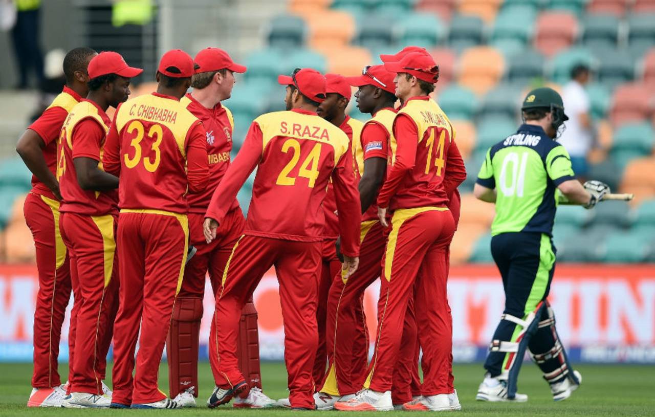 Zimbabwe players celebrate as Paul Stirling walks off, Ireland v Zimbabwe, World Cup 2015, Group B, Hobart, March 7, 2015