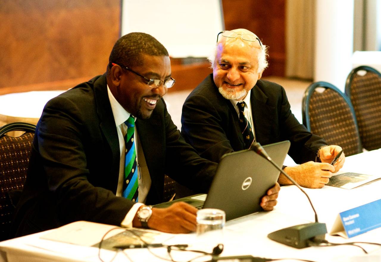 West Indies' Dave Cameron and Singapore's Imran Khwaja share a joke at the ICC board meeting in London, October 18, 2013