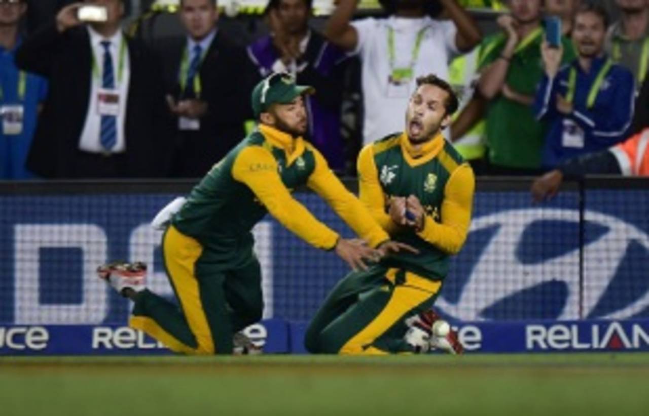 The fatal collision: Farhaan Behardien and JP Duminy spill Grant Elliott after bumping into each other, New Zealand v South Africa, World Cup 2015, 1st Semi-Final, Auckland, March 24, 2015