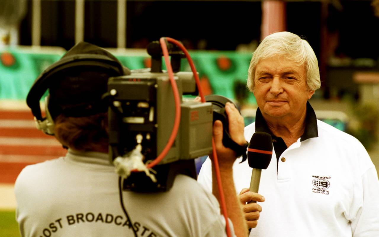 Richie Benaud gets ready for the camera while covering the Commonwealth Games in Kuala Lumpur, September 15, 1998