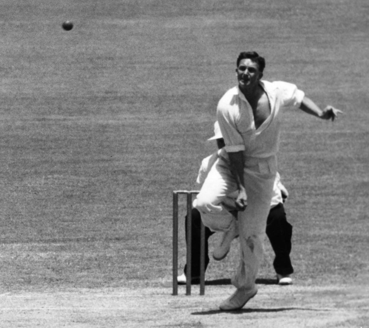 Richie Benaud bowls during a match in Sydney, January 1, 1958