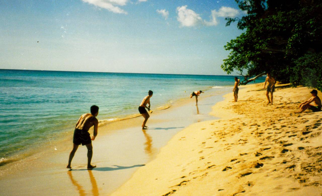 British university students play on a beach in Barbados, 1994