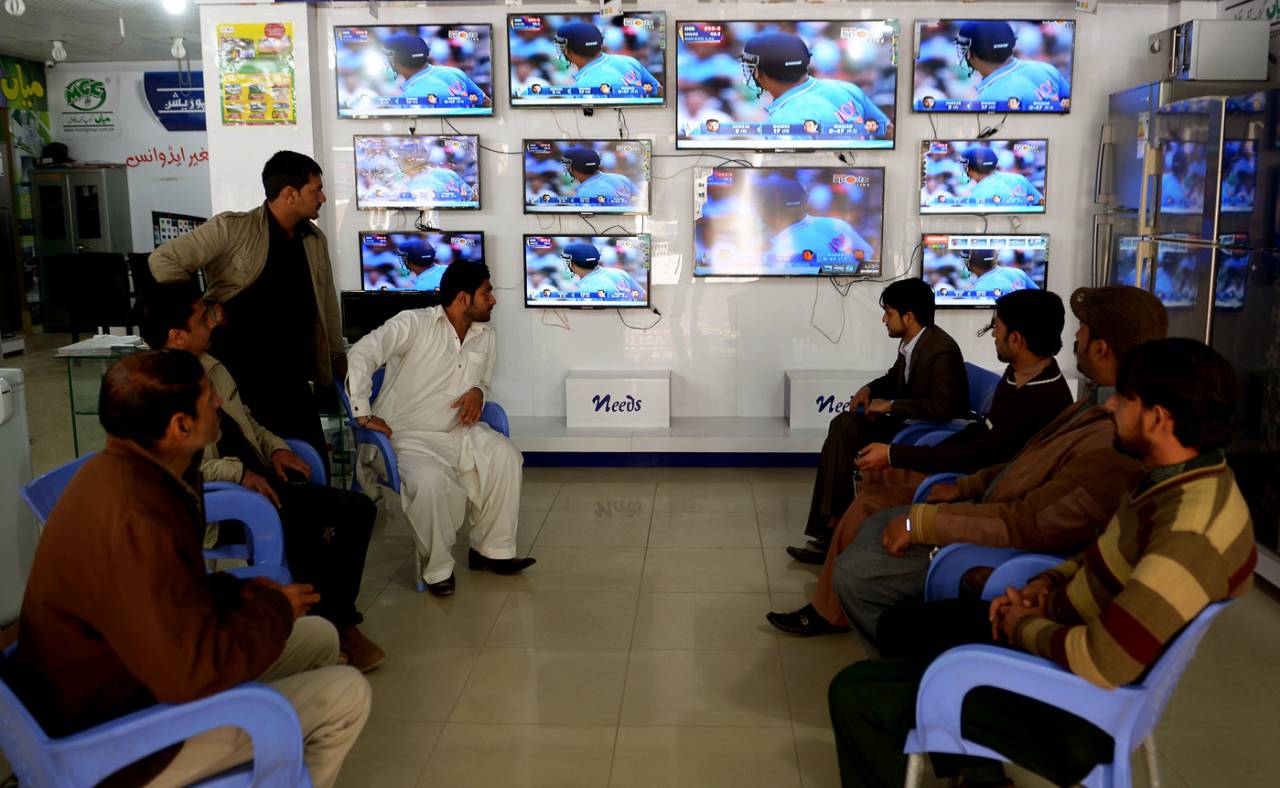 Pakistani shopkeepers watch the live broadcast of the India-Pakistan World Cup match at a market in Rawalpindi, February 15, 2015