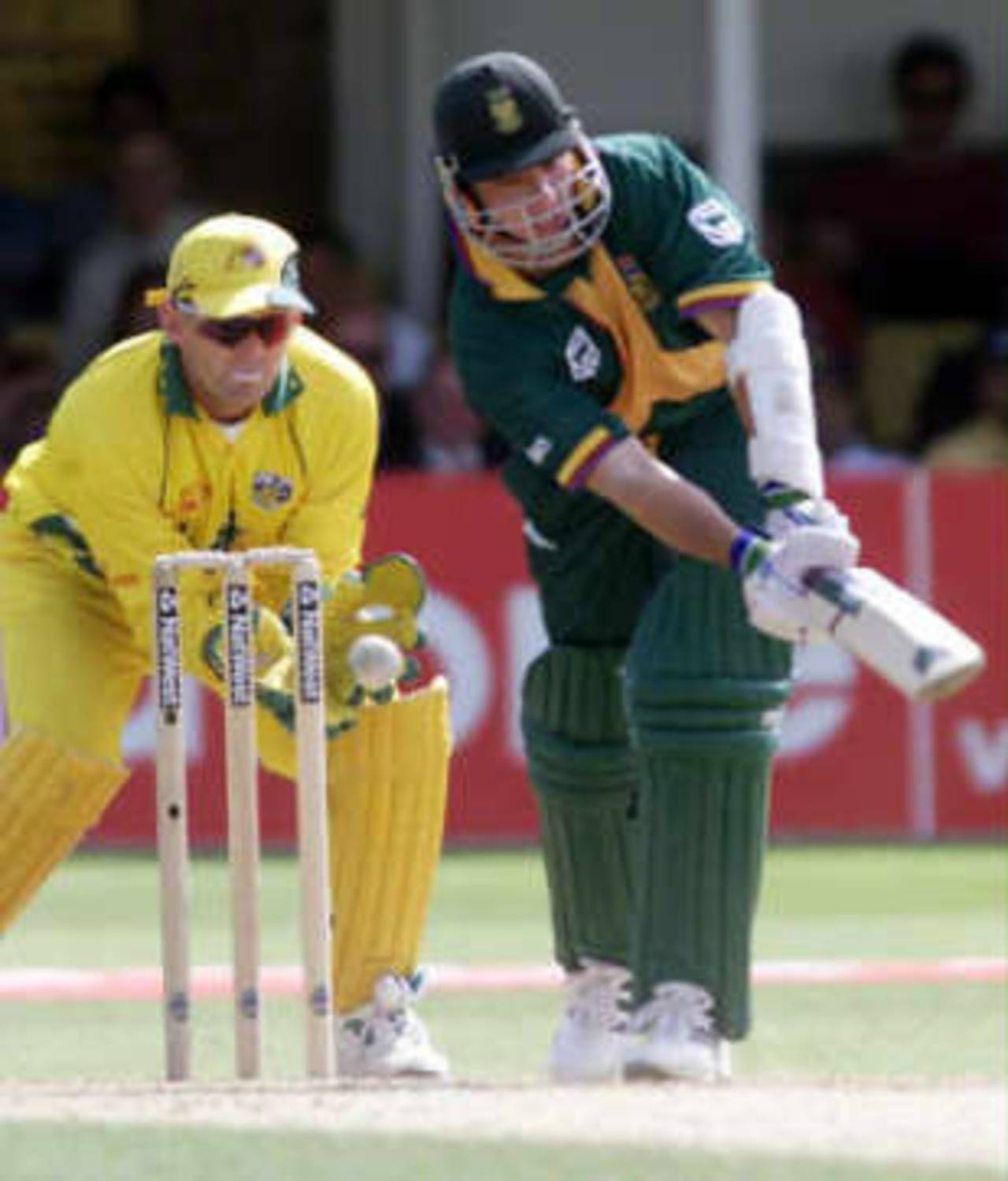 South Africa's Herschelle Gibbs (R) misses his shot as he is bowled by Australia's Shane Warne 17 June 1999,  during their semi-final match in the Cricket World Cup at Edgbaston, Birmingham. The final will be at Lords  20 June 1999