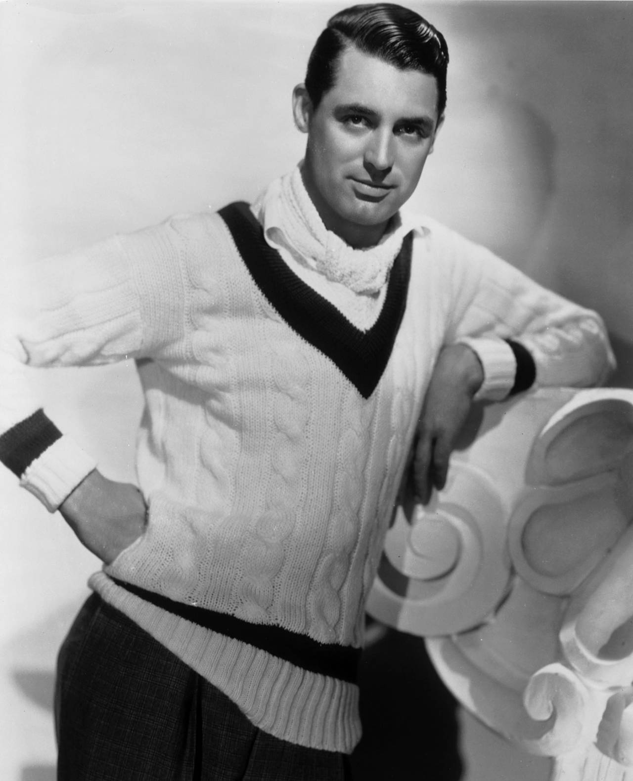 Cary Grant poses in a cricket sweater, 1934