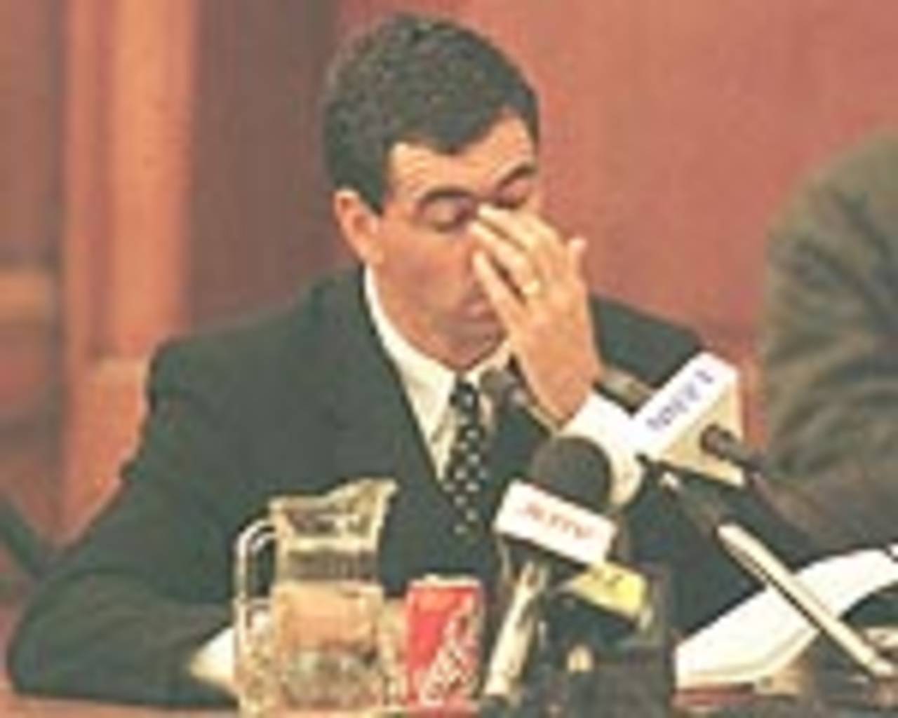 Former South African cricket captain Hansie Cronje wipes his eye during his cross-examination at the King Commission of Inquiry into allegations of cricket match-fixing in Cape Town 21June 2000.