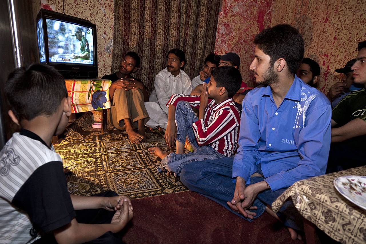Fans in a Karachi house watch a cricket match on television, Karachi, March 23, 2001