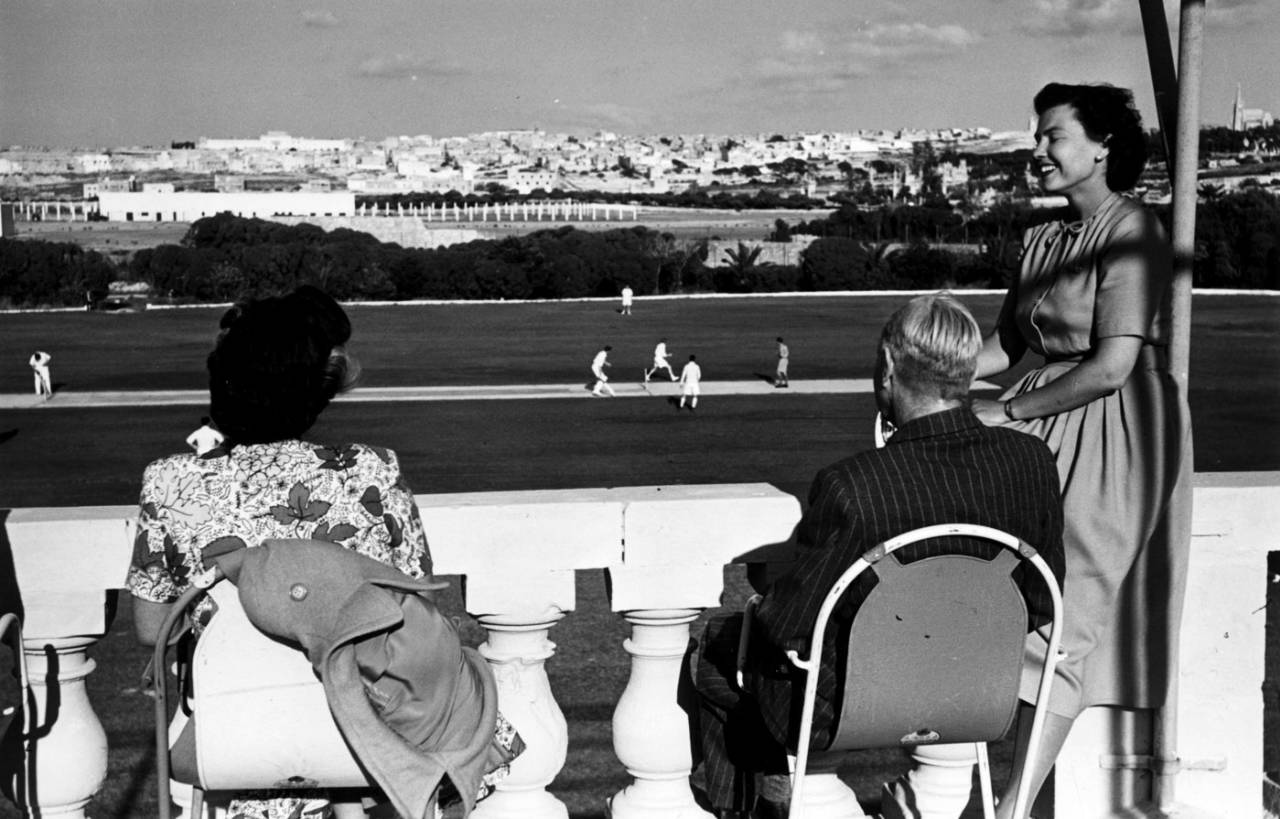 Spectators watch cricket from the pavilion at Marsa Cricket Club in Malta, September 17, 1949