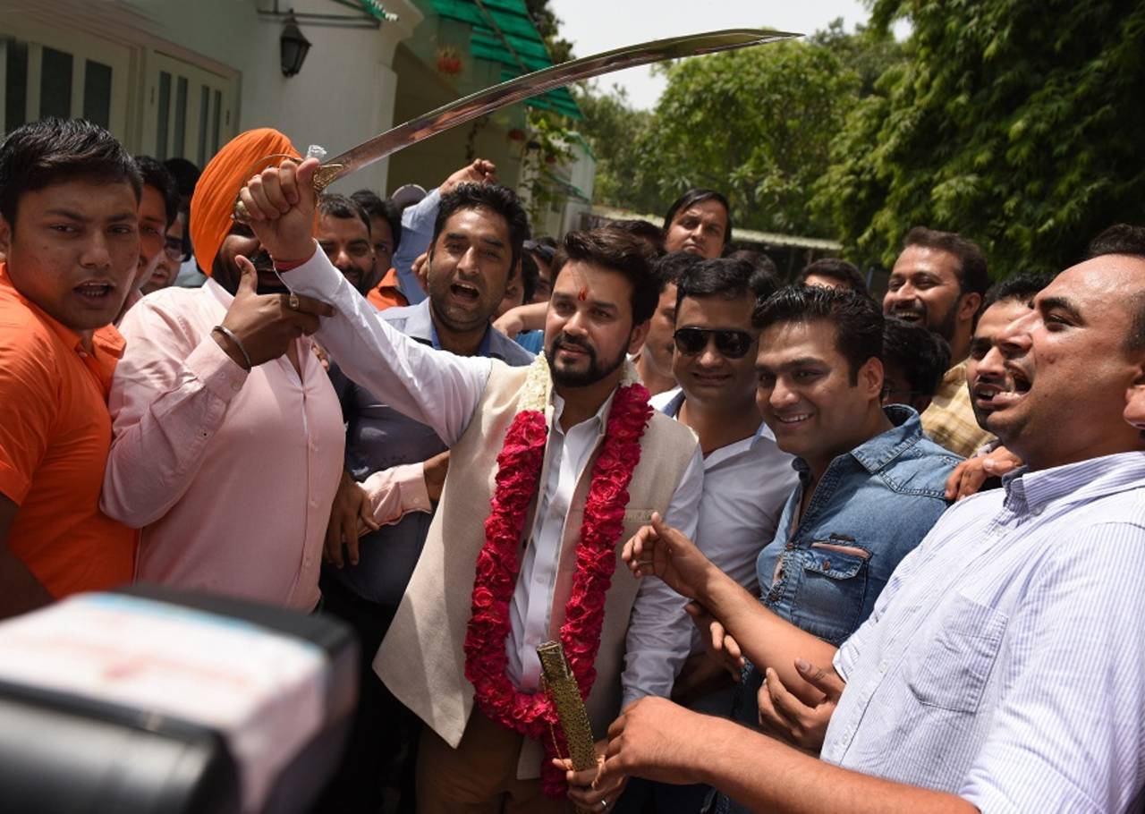Anurag Thakur holds a ceremonial sword amid celebrations on becoming the BCCI president, New Delhi, May 23, 2016