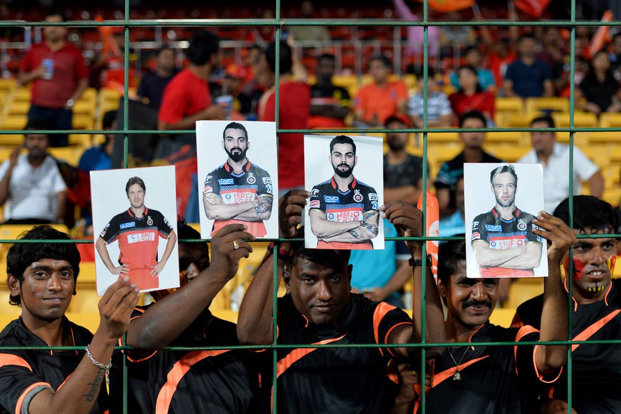 Fans hold up the photos of Royal Challengers Bangalore players: Shane Watson, KL Rahul, Virat Kohli and AB de Villiers, IPL 2016, Qualifier 1, Bangalore, May 24, 2016