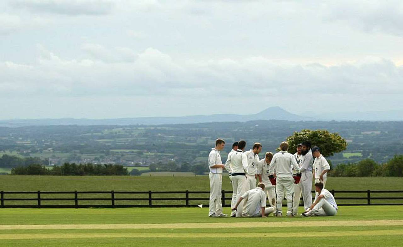 Club cricketers relax during a break in play, England