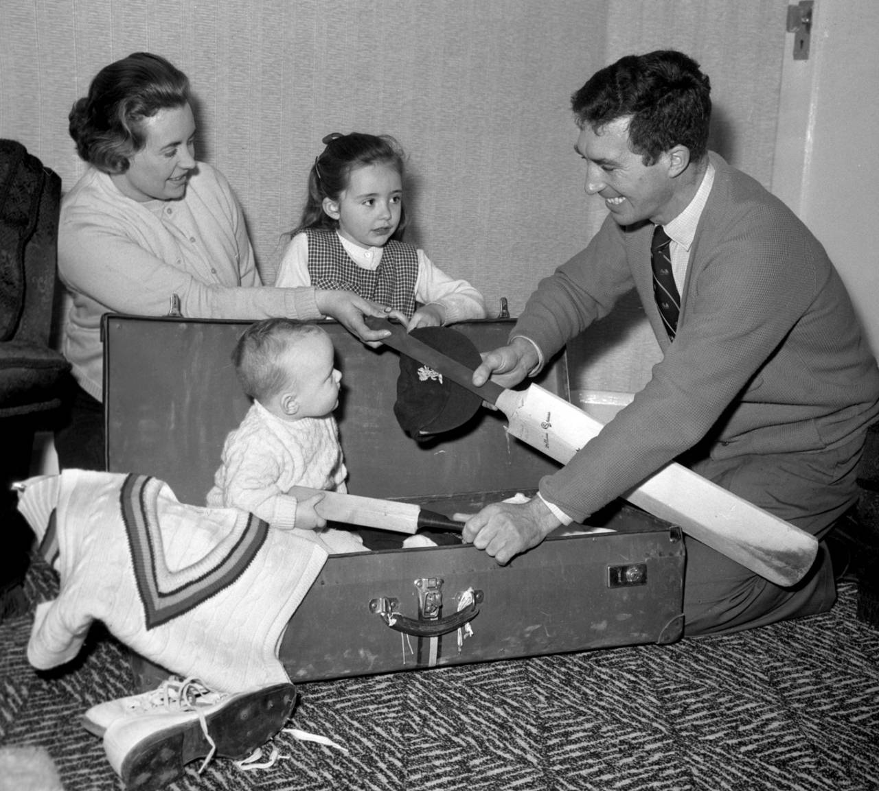 Fred Titmus gets help from his son Mark, daughter Dawn and wife Jean in packing for his tour to India, Enfield, December 18, 1963
