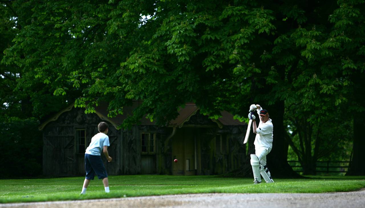 A father and son play in front of the pavilion of Castle Ashby House Cricket Club, May 20, 2007
