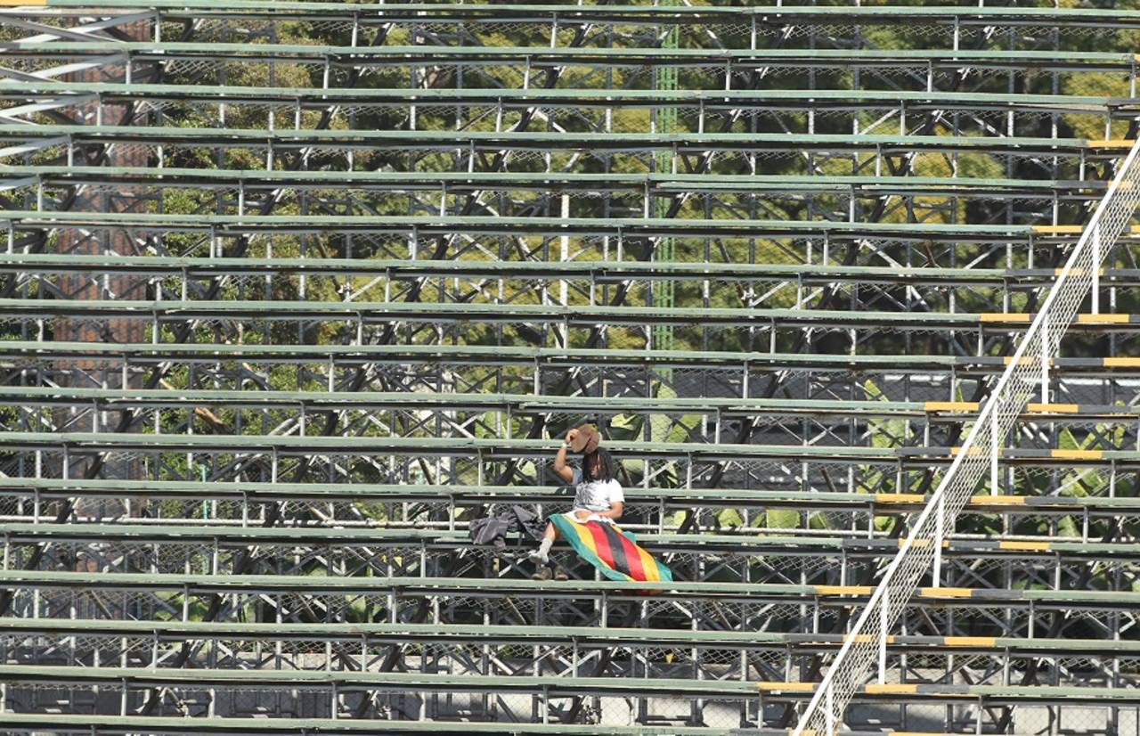 In the spotlight: A lone Zimbabwe fan takes cover from the sun , Zimbabwe v India, Harare, June 15, 2016