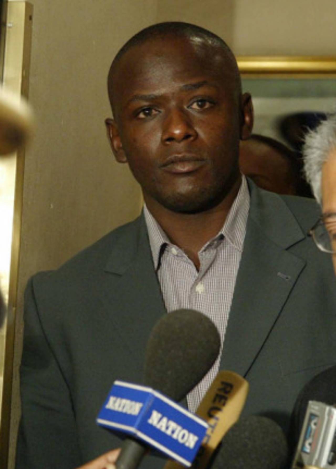 Maurice Odumbe and his lawyer in court, June 19, 2004