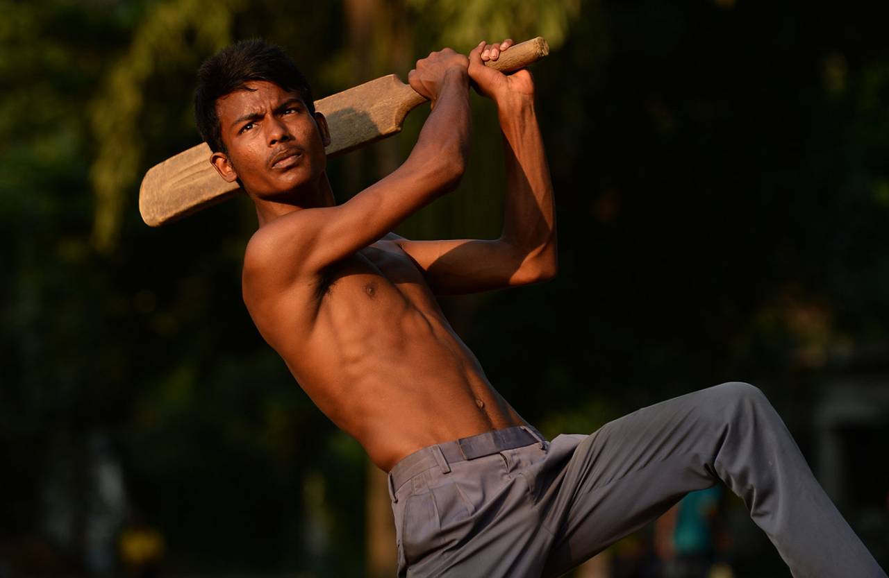 A youngster plays cricket in a park in Dhaka, November 2016