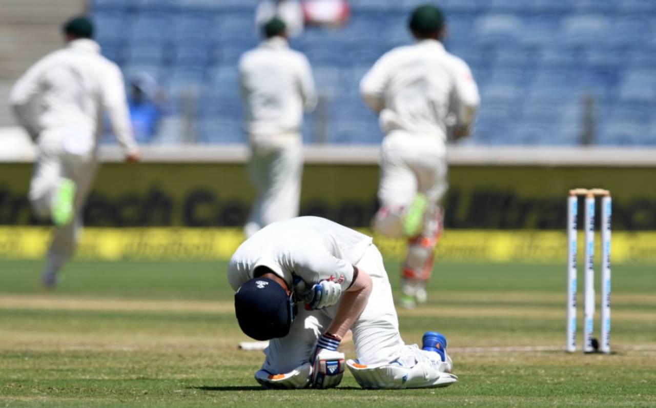 KL Rahul clutches his shoulder after holing out while the Australia players celebrate, India v Australia, 1st Test, Pune, 2nd day, February 24, 2017