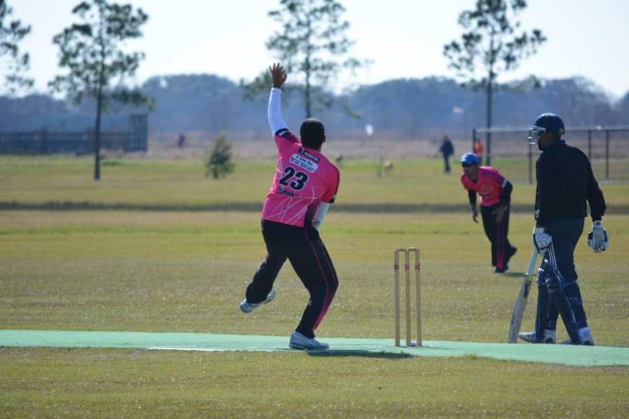 A bowler winds up to bowl in Houston's cricket league