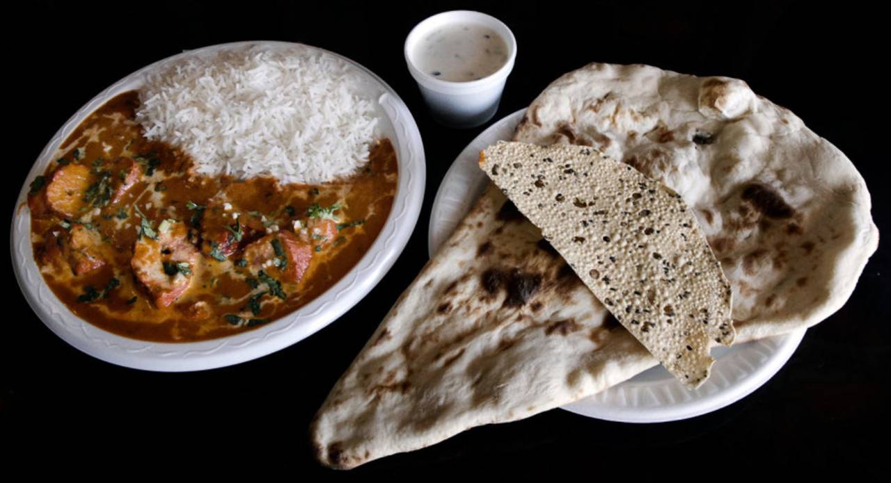 Butter chicken, rice, yoghurt raita, naan and papad