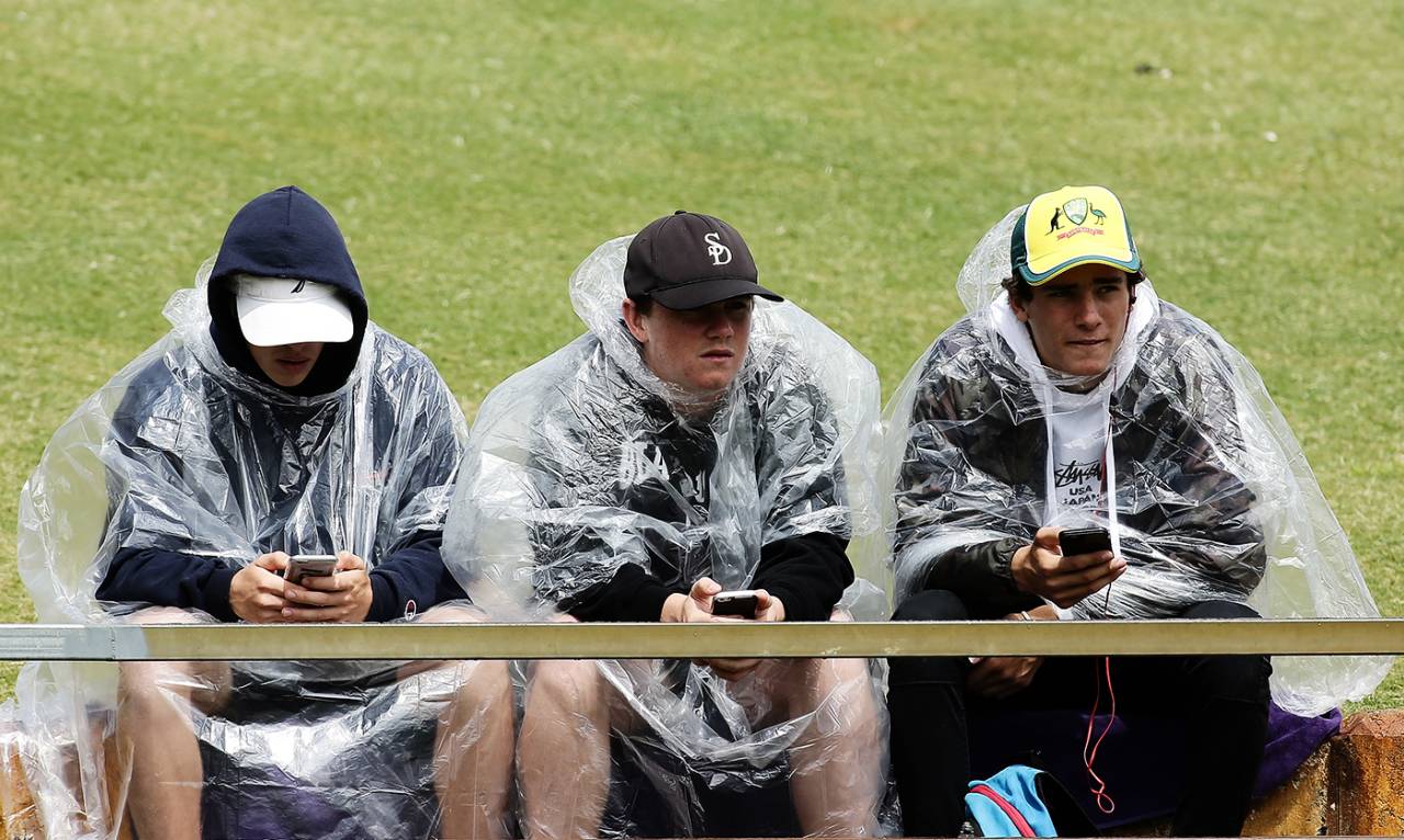 Spectators use their phones during a rain interruption, Australia v England, 3rd Test, Perth, 5th day, December 18, 2017