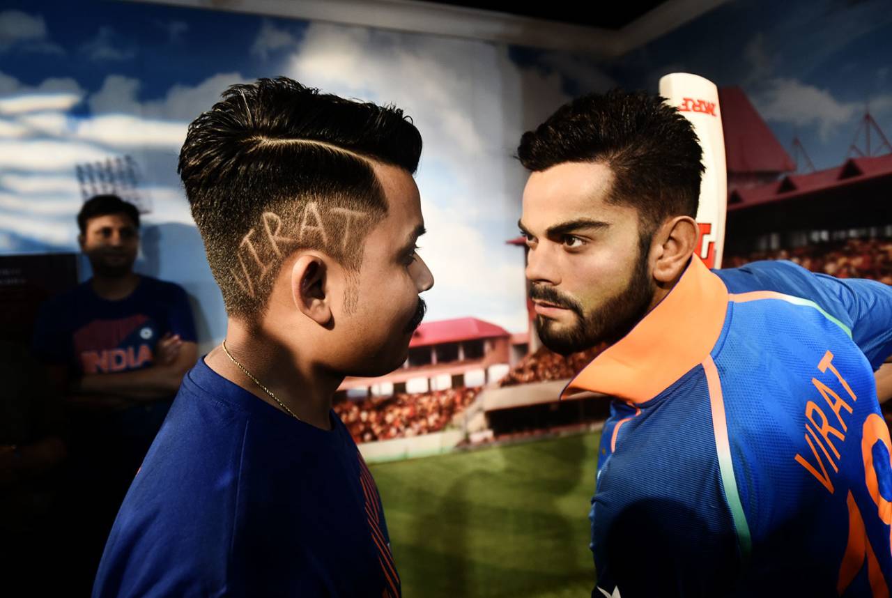 A visitor looks at Virat Kohli's wax statue at Madam Tussade's Museum in Regal Building, Connaught Place, New Delhi, June 6, 2018