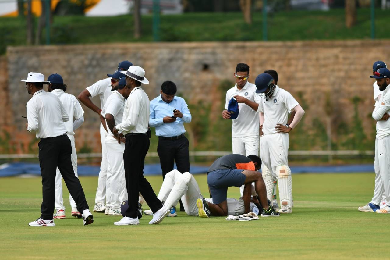 Priyam Garg gets attention from the team physio after being struck on the neck, India Green v India Red, Duleep Trophy, 4th day, Alur, September 1, 2019