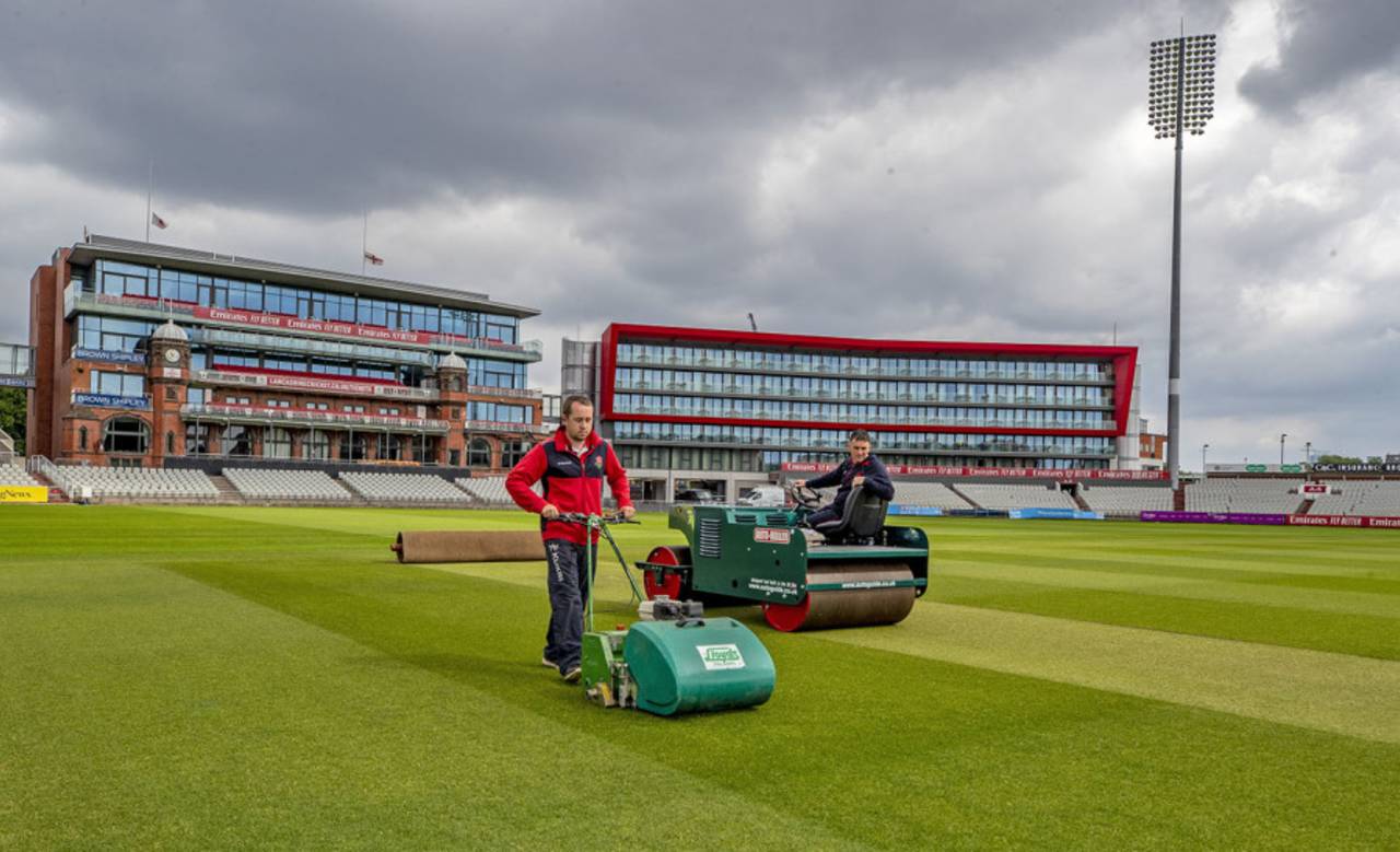 Lancashire's groundstaff work on the pitch at Emirates Old Trafford, May 21, 2020