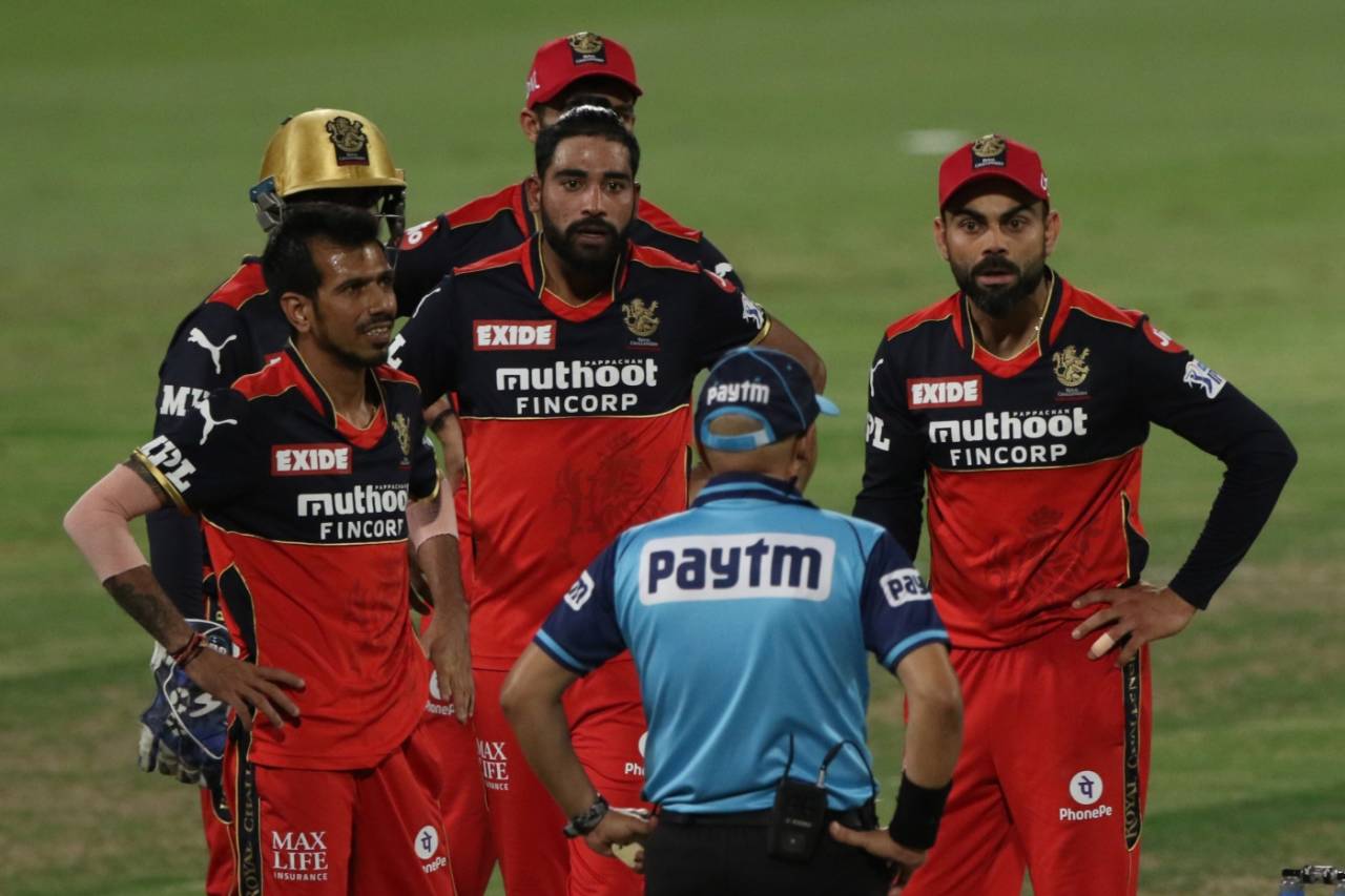 Virat Kohli was not a happy man as RCB had to review - successfully - to have a lbw call against Rahul Tripathi given. Here he talks to umpire Virender Sharma, Kolkata Knight Riders vs Royal Challengers Bangalore, IPL 2021, Eliminator, Sharjah, October 11, 2021
