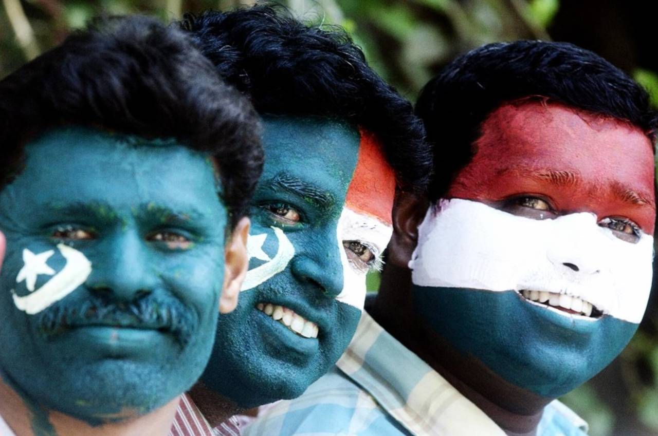 Fans in Bangalore pose with the India and Pakistan flags painted on their faces, March 12, 2004
