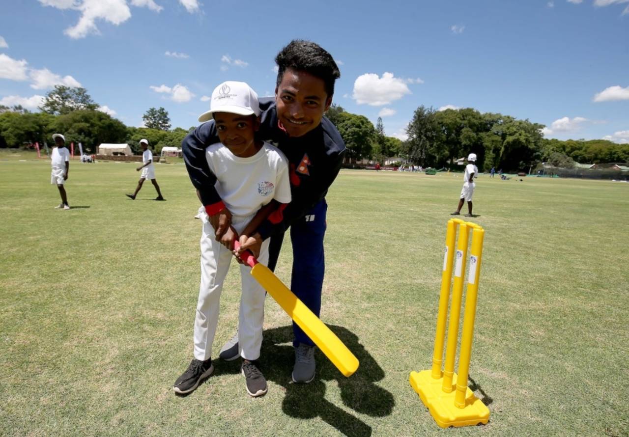Rohit Paudel coaches a child at the Nepal Cricket for Good event before the game against Afghanistan, ICC World Cup Qualifier 2018, Bulawayo, March 9, 2018