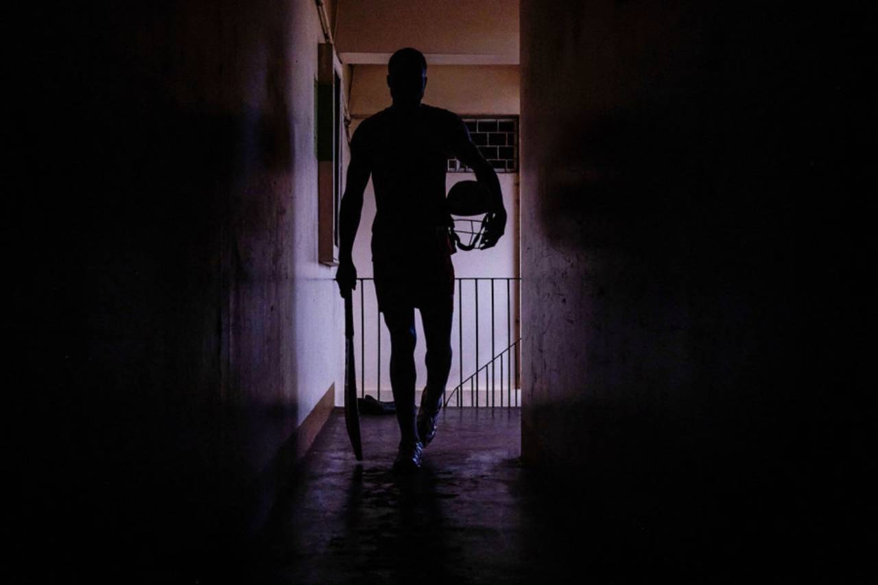 The silhouette of a Uganda player exiting the dressing room with his bat and helmet, Kampala, May 17, 2024