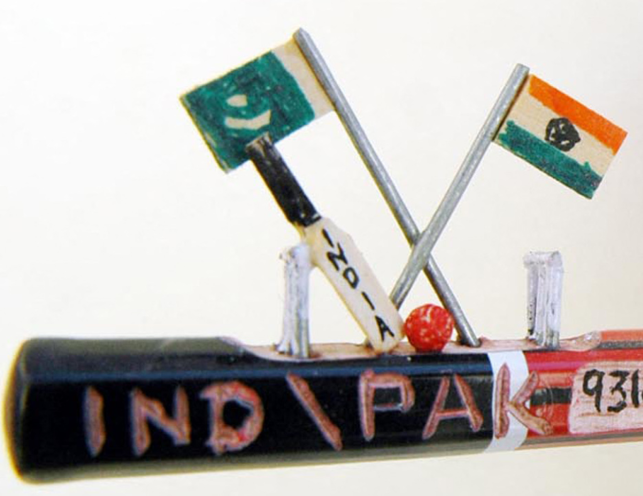 A miniature pitch with bat, ball, stumps and the flags of India and Pakistan mounted on a pencil, Amritsar, April 18, 2006