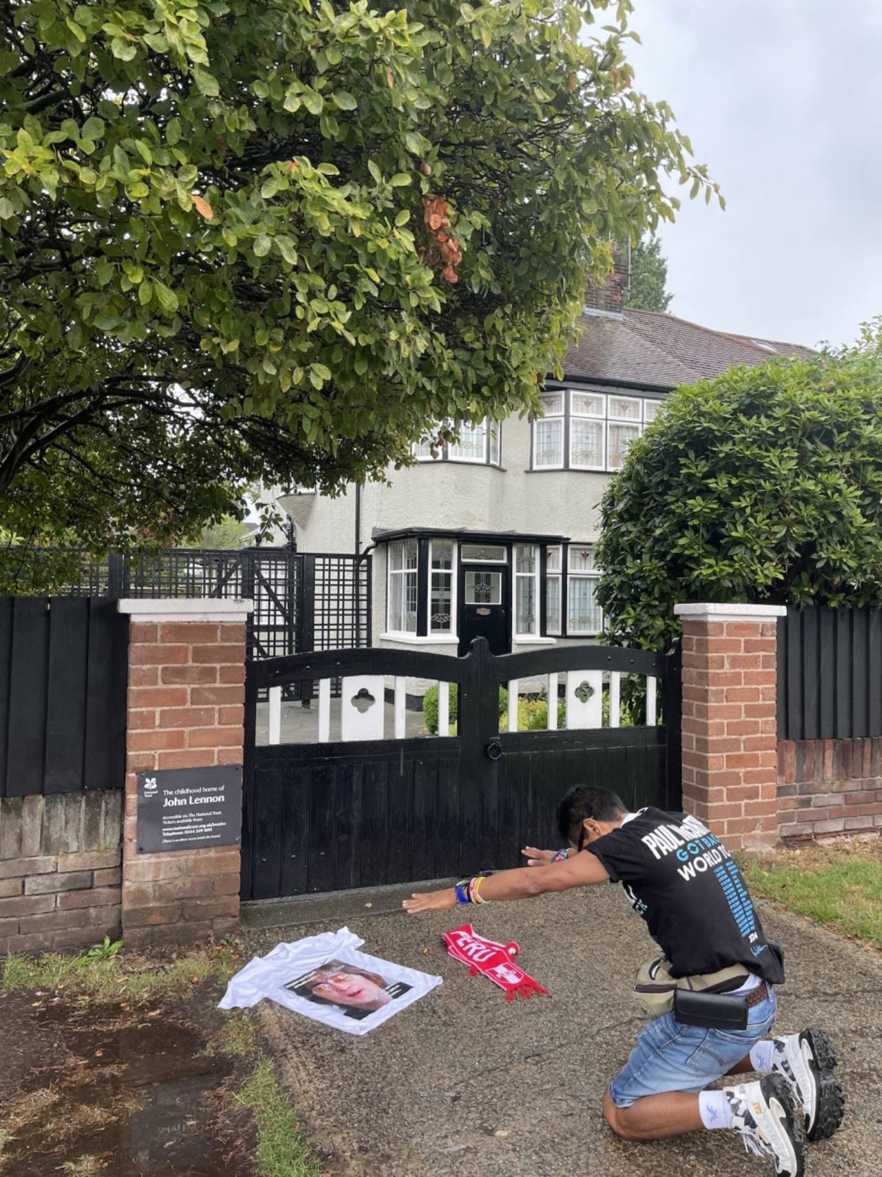A fan pays homage outside John Lennon's childhood home, Liverpool, July 21, 2025