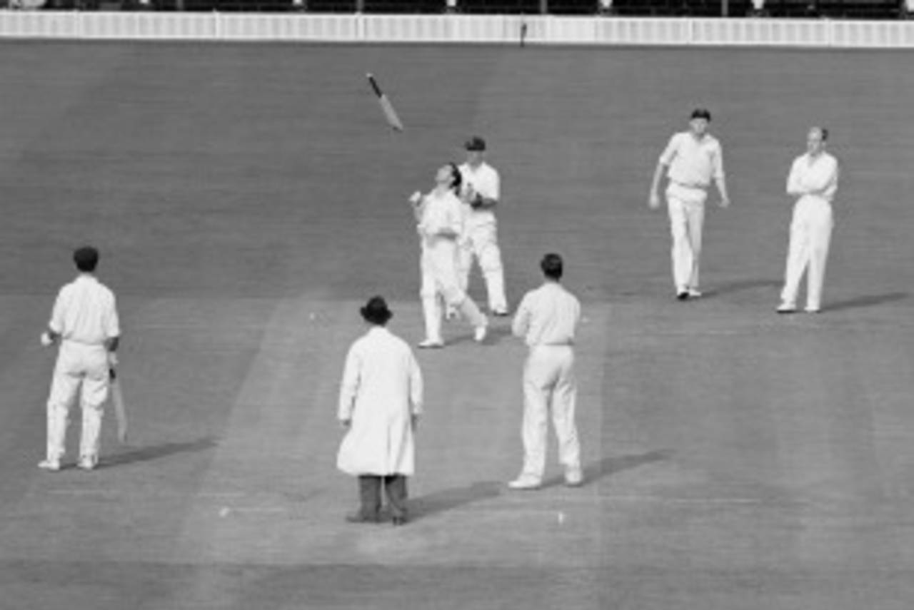Neil Harvey throws his bat up in the air after being bowled by Jim Laker, England v Australia, fourth Test, fifth day, Old Trafford, July 31, 1956