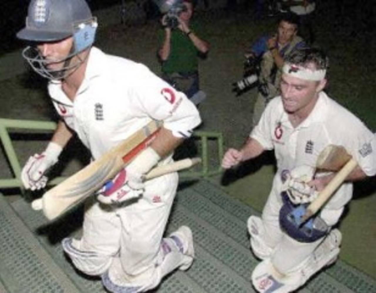 England captain Nasser Hussain (L) and Graham Thorpe (R) rush to the English dressing room after their nail bitting victory by six wickets against Pakistan on the last day of the third cricket Test match at the National Stadium in Karachi, 11 December 2000. England clinched a historic series victory, snatching a stunning win with just minutes to spare in the third and final Test. England's six-wicket triumph makes them the first English side to win a Test in Pakistan since 1962 and end the hosts' unbeaten record in 34 encounters.