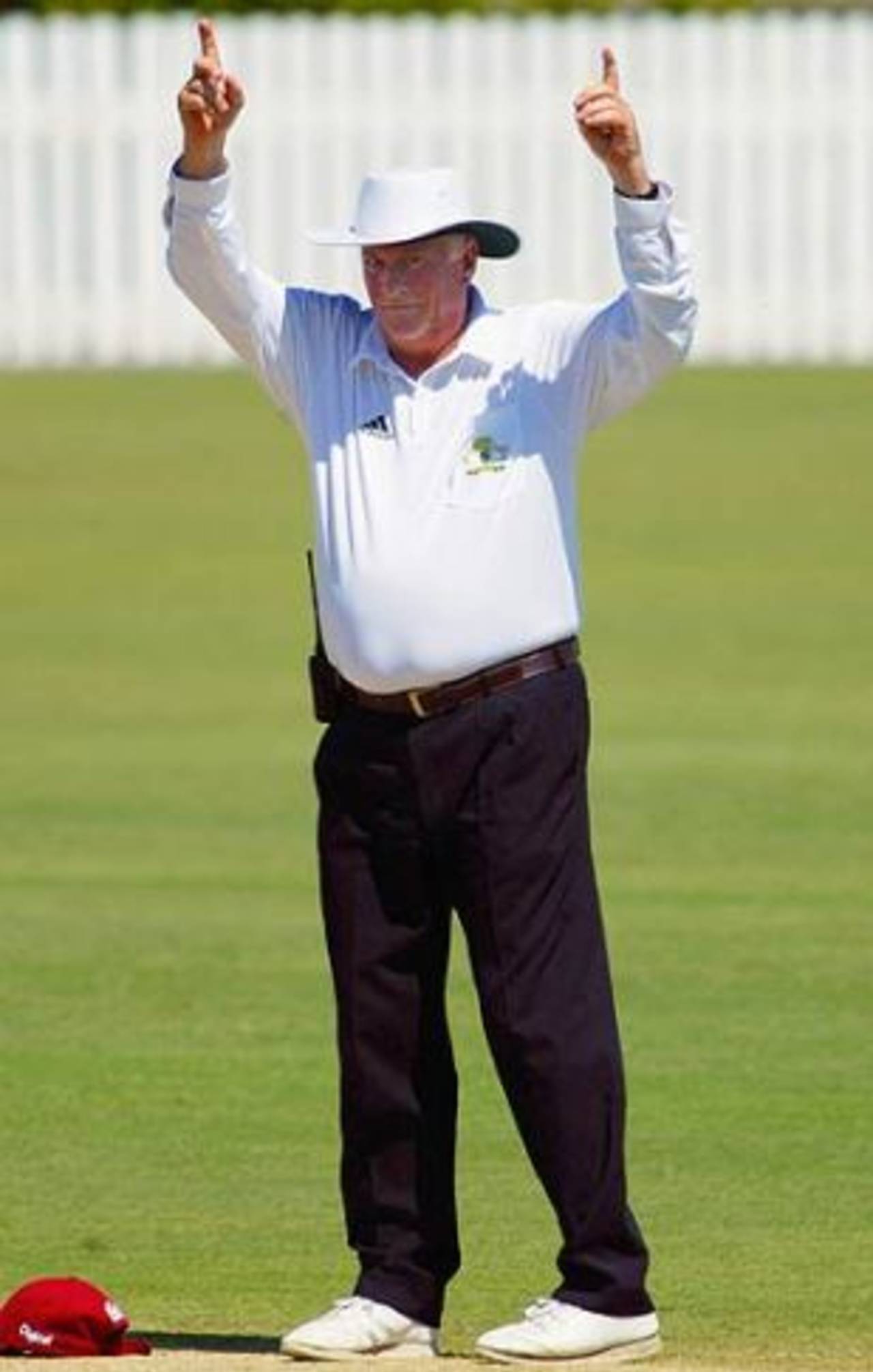 Umpire Dave Orchard signals six runs, Queensland v West Indians, Allan Border Field, Brisbane, 1st day, October 27, 2005