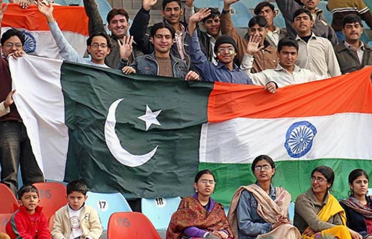 Cricket fans hold Pakistani and Indian flags during the first day, Pakistan v India, 1st Test, Lahore, 1st day, January 13, 2005
